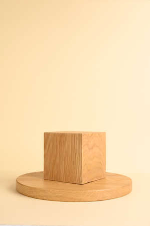 Wooden podium on beige background for product presentation. Front view. Copy space. Verticalの写真素材