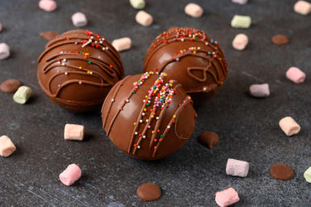 Cocoa bombs with marshmallows, chocolate that melts when hot milk is added for creating a trendy tasty drink.の写真素材