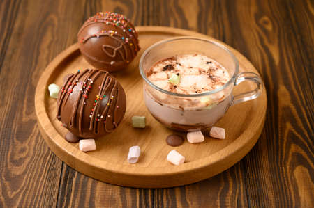 Cocoa bombs with marshmallows, chocolate that melts when hot milk is added for creating a trendy tasty drink. Front view.の写真素材