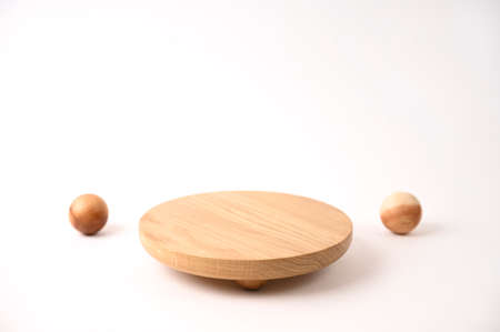 Round wooden podium on white background for product presentation. Front view. Copy space.の写真素材