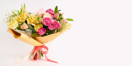 Banner with beautiful flowers in vase on a table with white background. Women's, mother's day, love concept. Spring, summer season. Front view.の写真素材
