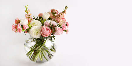 Banner with beautiful flowers in vase on a table with white background. Women's, mother's day, love...