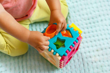 The child collects a multicolored sorter. Educational logic toy for kidsの写真素材