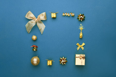 Christmas composition with gifts, pine branches, toys on blue background. Flat lay, top view.の写真素材