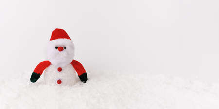Santa Claus doll toy on christmas time, background with snow. Front view. Banner. Copy space. Empty space to the text.の写真素材