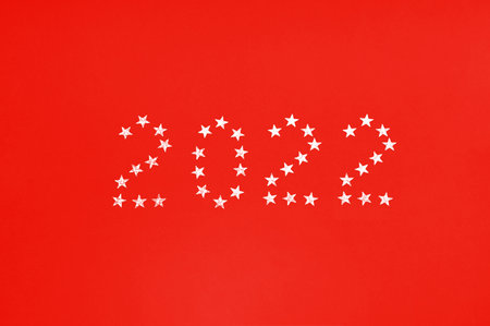 Numbers 2022 made of glitter stars on red color background. Happy New Year.の写真素材