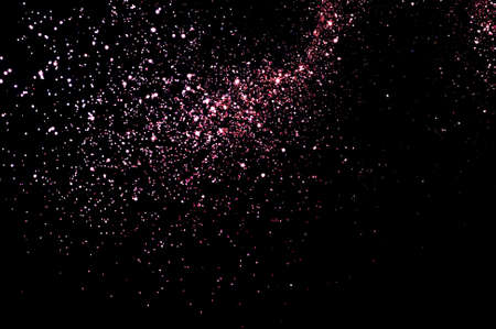 Sparkly glitter on black background. Christmas, new year, festive concept. Copy spaceの写真素材