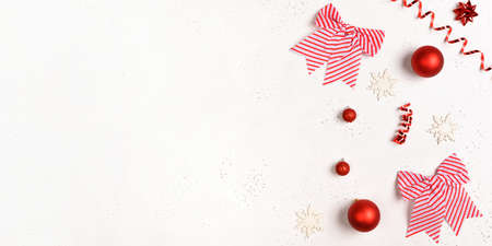 Christmas frame with balls, red, golden decorations on white background with empty space to the...