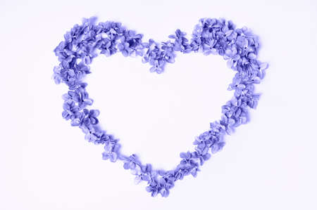 Heart of lilac flowers. Trendy color of the year 2022. Very peri. Flat lay, top view, copy spaceの写真素材