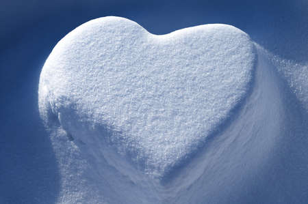 Snow heart - symbol of love. Valentines day, winter concept.の写真素材
