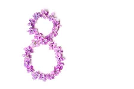 Flowers in the shape of the number 8 on white background. Flat lay, top view, copy space....