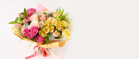 Beautiful flowers in vase on a table with white background. Womens, mothers day, love concept. Spring, summer season. Bannerの写真素材