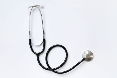Stethoscope on a white background, top view. Medical instrument. Cardiology and medicine concept, healthcare. Auscultation device