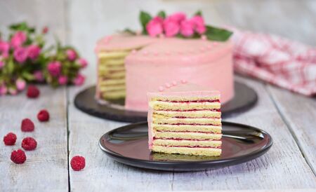 Slice of layered creamy fruit cake. Raspberry layer cake