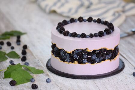 Purple beautiful cake decorated with berries, blackberries and blueberriesの写真素材