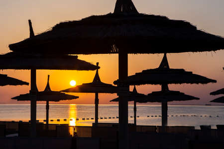 Traveling for refreshing mind to the Hurghada, Egypt. Watch Sunrise at the sea Beach. In 2020. Silhouette of straw umbrellas.の写真素材