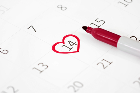 Calendar page with the red hearts from tapes on February 14 of Saint Valentines dayの写真素材