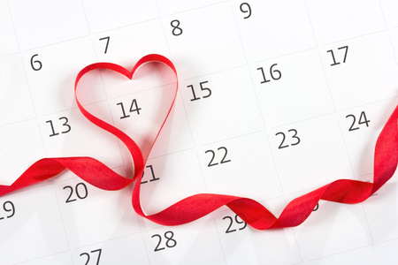 Calendar page with the red hearts from tapes on February 14 of Saint Valentines dayの写真素材