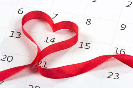 Calendar page with the red hearts from tapes on February 14 of Saint Valentines dayの写真素材