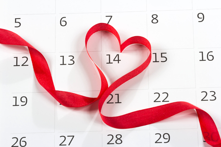 Calendar page with the red hearts from tapes on February 14 of Saint Valentines dayの写真素材