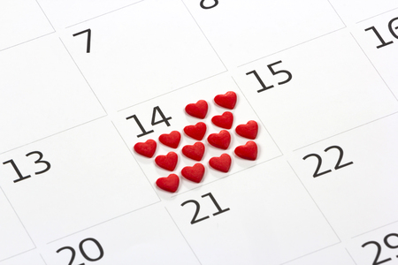 Calendar page with the red hearts from tapes on February 14 of Saint Valentines dayの写真素材