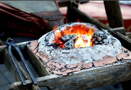 Appliances for the blacksmithing with small fire insideの写真素材