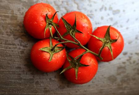Green salad and tomatoes on the textures dark grey backgroundの写真素材