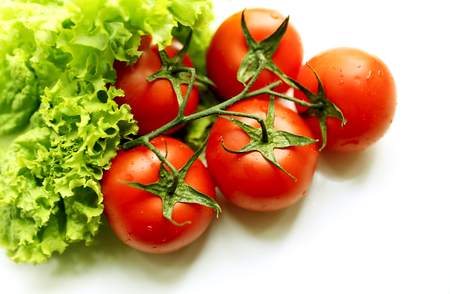 Green salad and tomatos on the textures dark grey backgroundの写真素材
