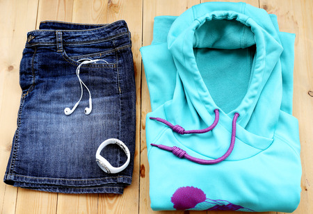 Outfit of casual sport woman. Blue denim skirt and light blue sweater with watchの写真素材