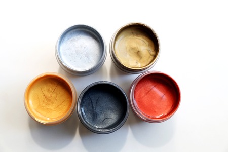 Set of colorful paints are located closed to red brushの写真素材