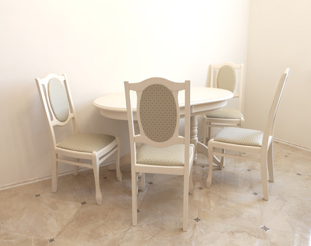 Beige classical dining room with roung table and chairs closed to the wallの写真素材