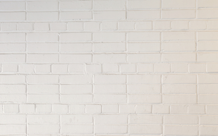 Background of the white brick wall. Bricks are merged with the cement strainer and can be used for backgroundの写真素材