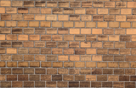 Background of the yellow brick wall. Bricks are merged with the cement strainer. you can use it as background for signatureの写真素材