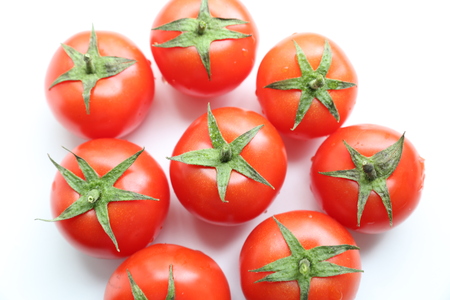 Bunch of red tasty fresh tomatos on the white background.の写真素材