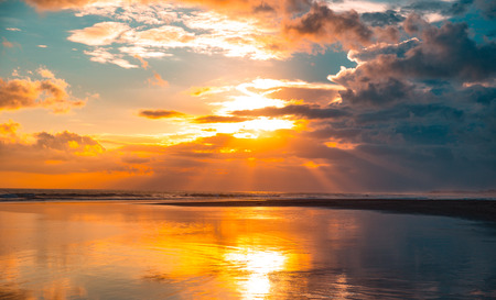 Panarama of the beautiful sunset on the ocean with cloudy skyの写真素材