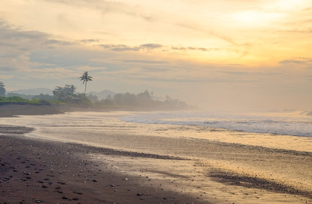Black sand beach on the sunrise with white Indian ocean. Nobody in the beach. Paradiseの写真素材