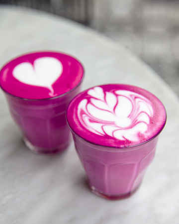 Two Beetroot super latte on marble background. Trandy healthy drinkの写真素材