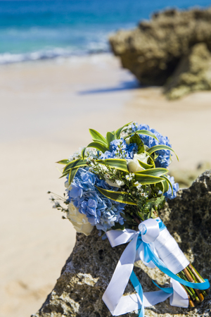 Bride wedding bouque is on the beachの写真素材