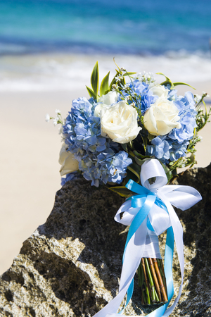 Bride wedding bouque is on the beachの写真素材