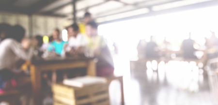 blurred background of talking people in coffee cafeの写真素材