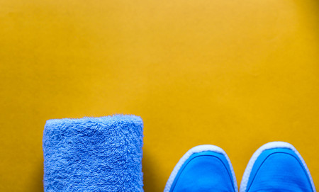 Flat lay sport shoes, bottle of water, towel on yellow background.の写真素材