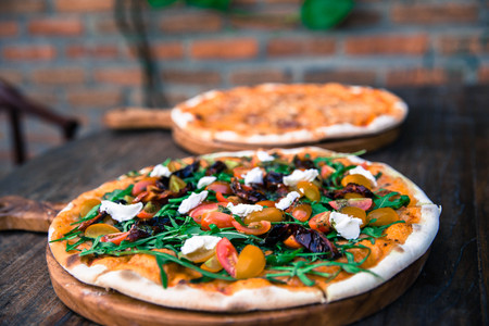 Two big Pizza Margarita and vegetable are ready to eat in the restaurantの写真素材