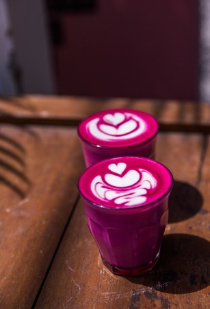 Two Beetroot super latte on marble background. Trandy healthy drinkの写真素材