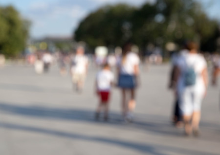 Crowd of anonymous people walking on street