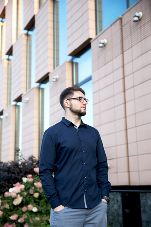 Young handsome man is standing closed to the building.の写真素材