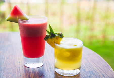 Two fresh juices on the wooden desk.の写真素材