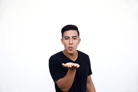 Handsome latin hispanic man making air kiss gesture to girlの写真素材