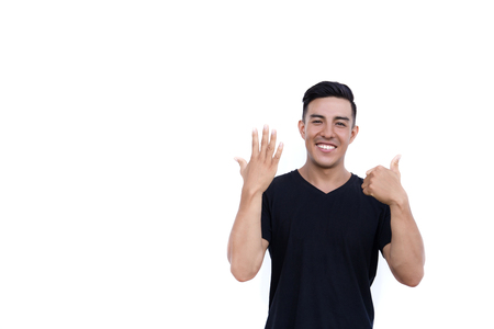 Handsome latin hispanic man is showing six fingers isolated on white background.の写真素材