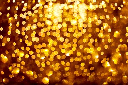 Blurred golden lights on black background.の写真素材