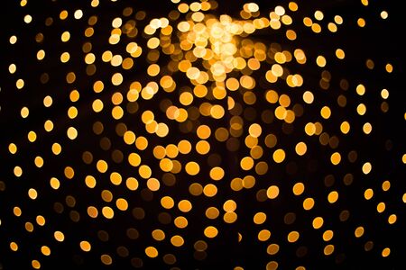 Blurred golden lights on black background.の写真素材